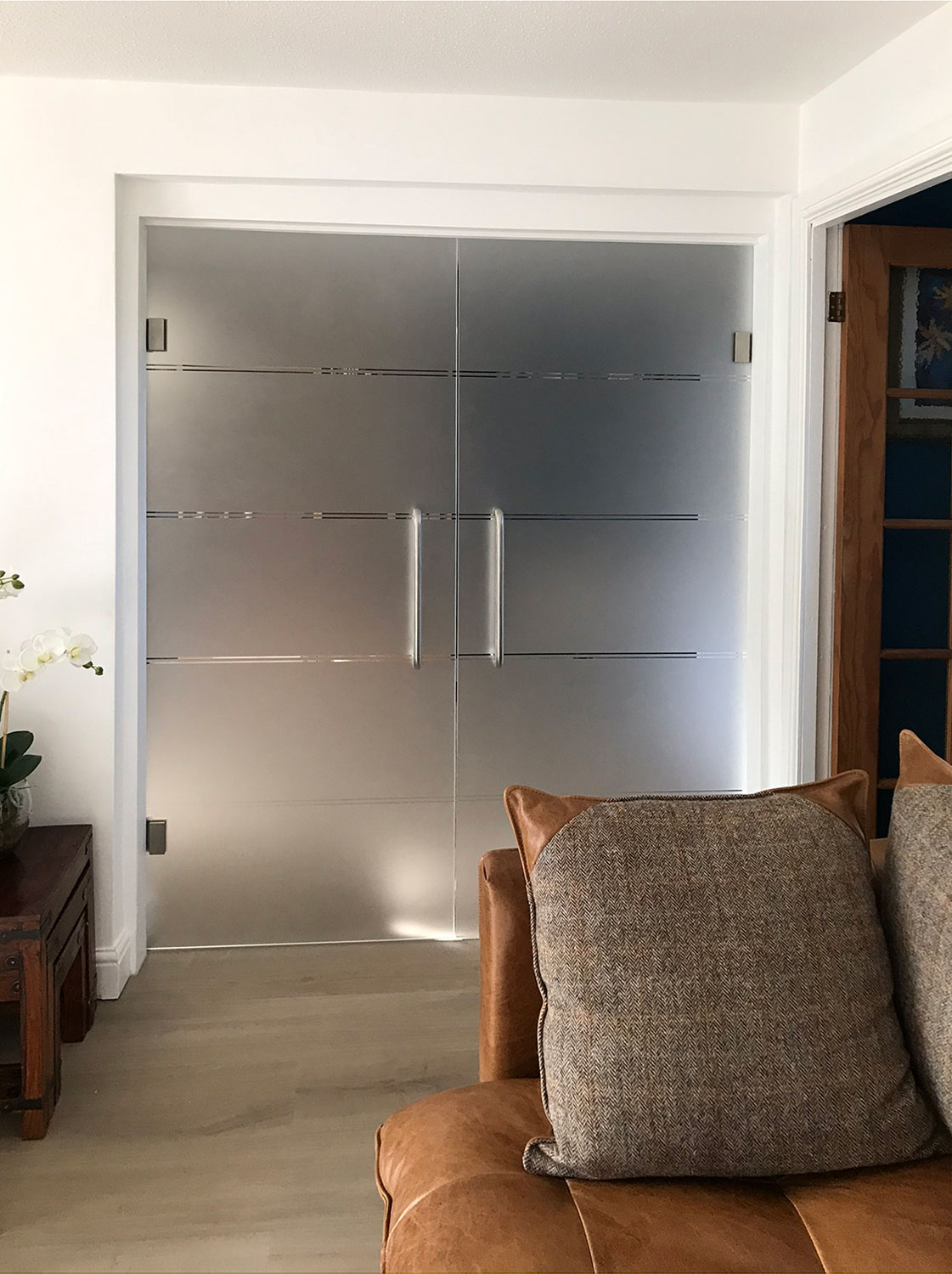 full glass double doors with pull bars fitted into door lining