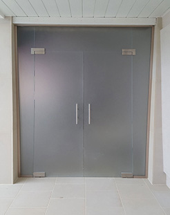 frameless glass partition with hinged doors and satin glass